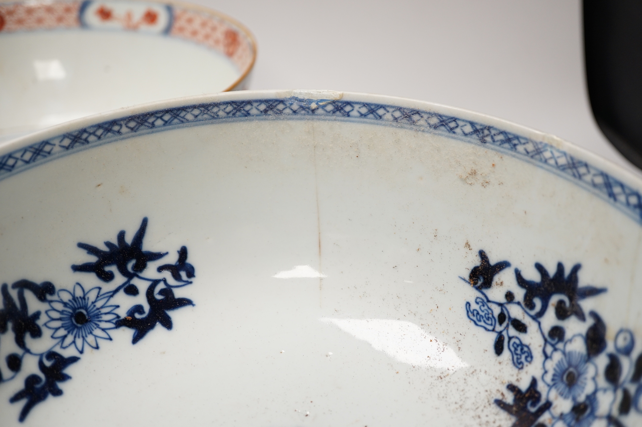 Four 18th century Chinese porcelain bowls (a.f), one with hardwood stand, largest 28cm diameter
